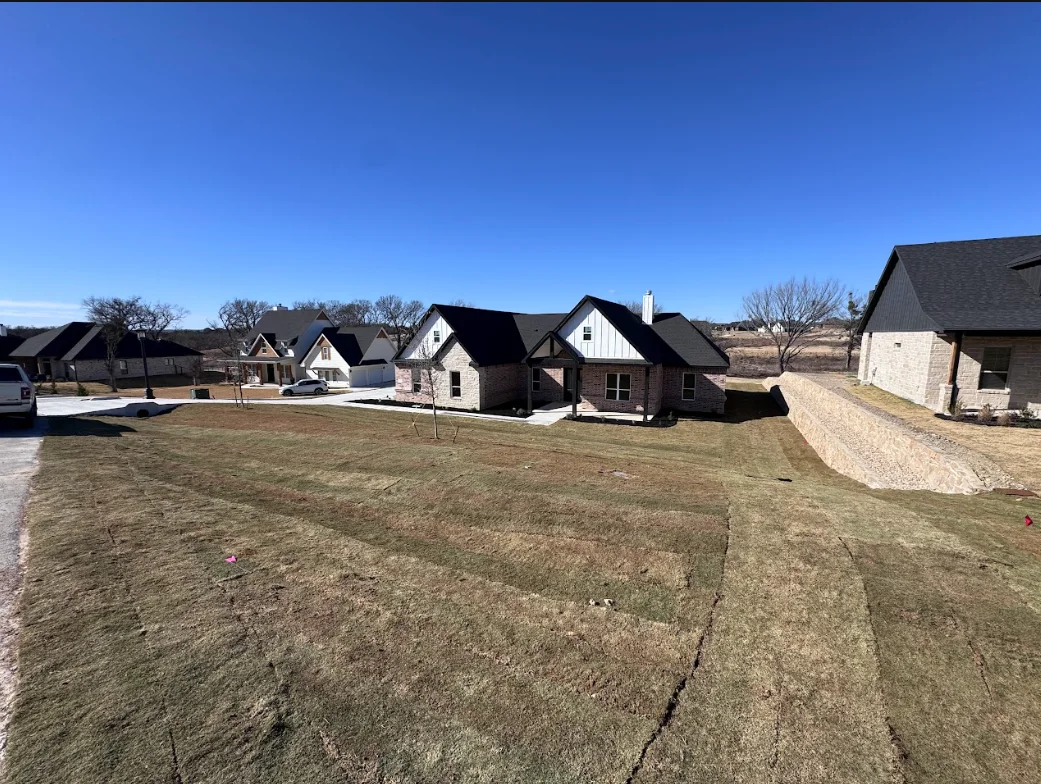 Graded residential lot with multiple new homes under construction in Weatherford